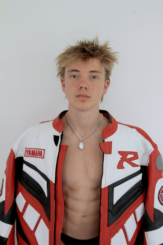 Man wearing large baroque pearl pendant on a chunky silver chain